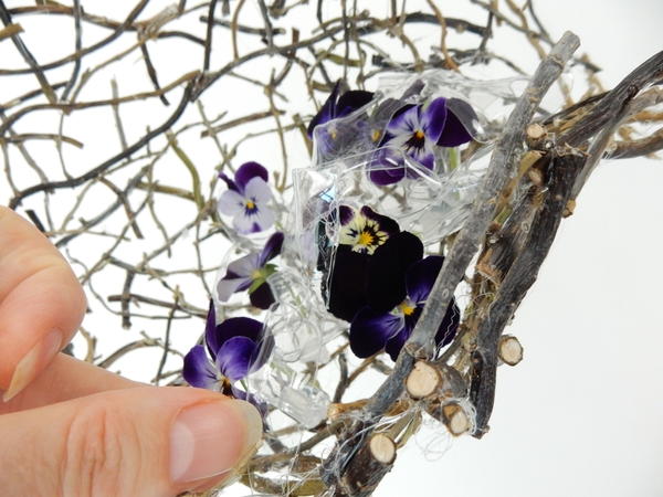 Add a few more plastic shapes so that the flowers peek through Add a few more plastic shapes so that the flowers peek through