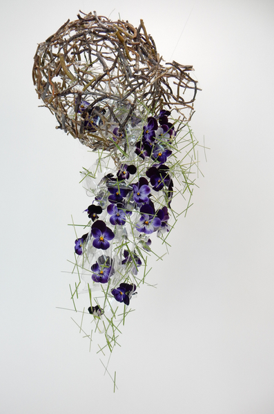 Flowers spilling from a twig vase