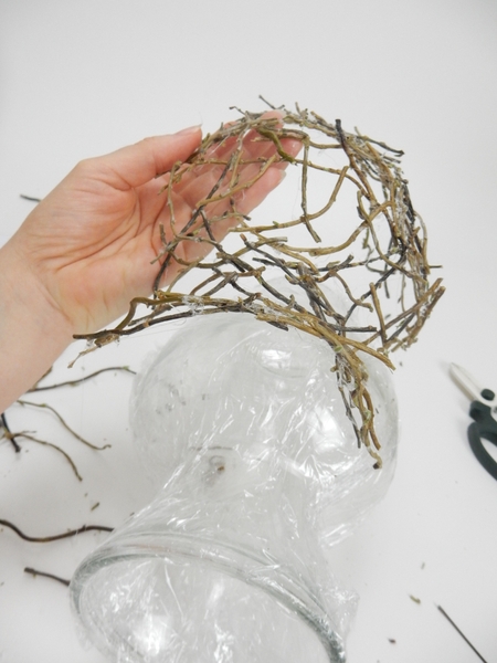 Lift the first half of the twig vase away and set it aside Lift the first half of the twig vase away and set it aside