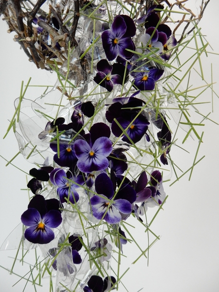 Melted plastic shapes as an armature for the pansies Melted plastic shapes as an armature for the pansies
