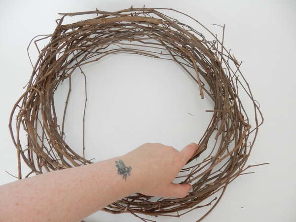Place a large wreath on a flat design surface Place a large wreath on a flat design surface