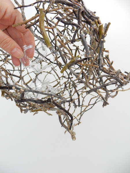 Place some of the plastic shapes in the twig shape Place some of the plastic shapes in the twig shape