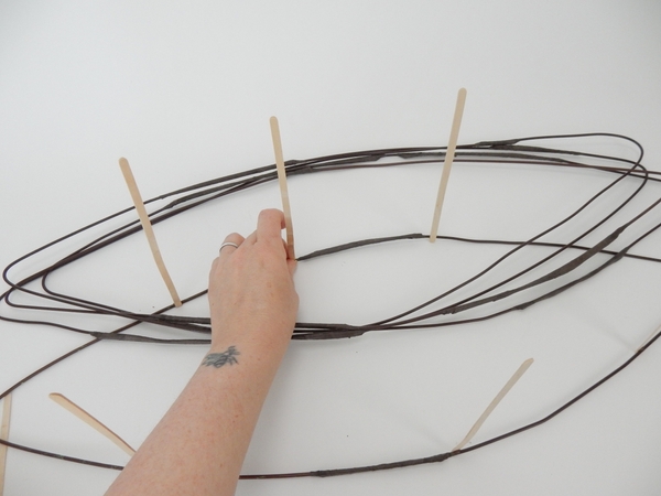 Glue in bamboo sticks to separate the wire into levels. Glue in bamboo sticks to separate the wire into levels.