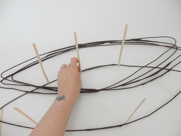 Glue in bamboo sticks to separate the wire into levels.