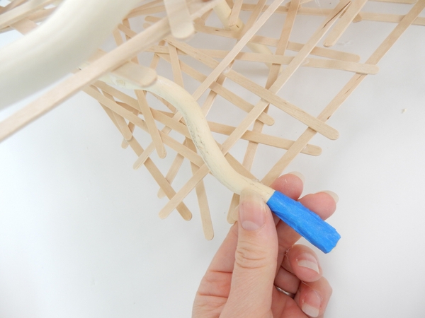 Glue in the stick so that only the blue tape sticks out from the bottom of the armature Glue in the stick so that only the blue tape sticks out from the bottom of the armature