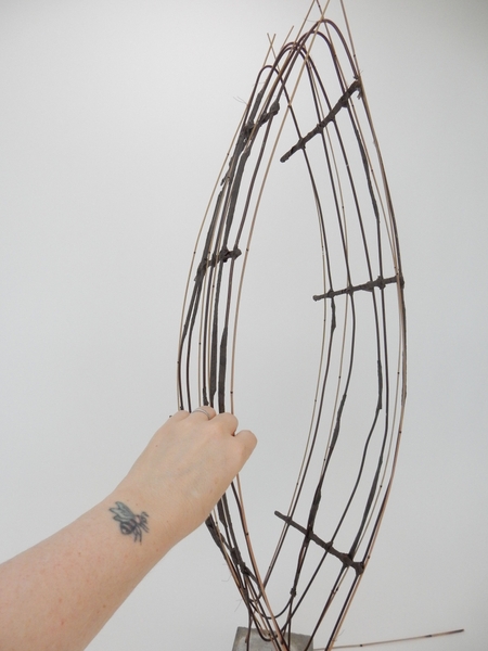 Keep adding reeds to follow the shape of the wire armature Keep adding reeds to follow the shape of the wire armature
