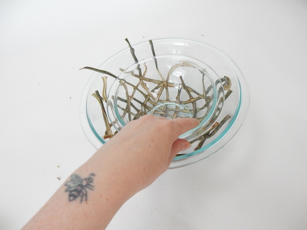 Lift the small bowl from the willow nest. Lift the small bowl from the willow nest.