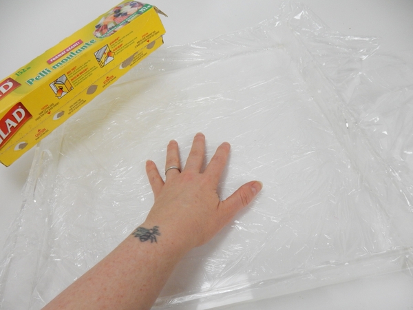 Line a deep square tray with plastic wrap Line a deep square tray with plastic wrap