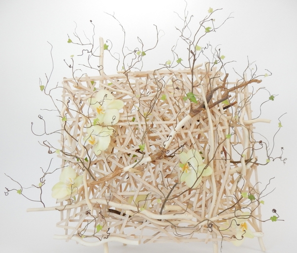 Phalaenopsis orchids, ivy, willow and grape vine tendrils on a popsicle stick armature Phalaenopsis orchids, ivy, willow and grape vine tendrils on a popsicle stick armature