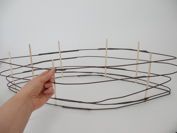 Secure the bamboo sticks with brown florist tape Secure the bamboo sticks with brown florist tape