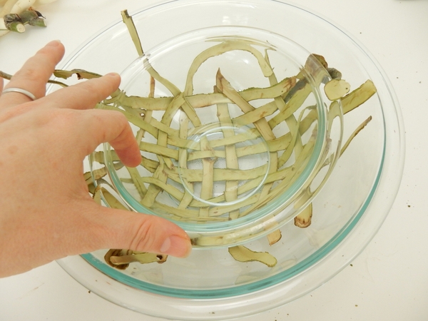 Set another bowl over the weave inside the larger bowl to press it into the dome shape