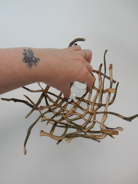 Set the nest over the neck of a small vase Set the nest over the neck of a small vase