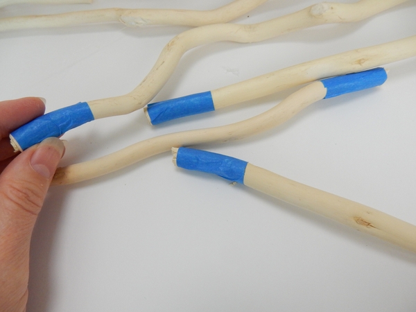 Wrap painters tape around the bottom of four willow sticks as spacers for the armature feet Wrap painters tape around the bottom of four willow sticks as spacers for the armature feet