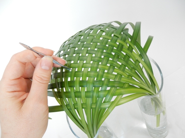 Adjust the weave to secure with the blunt side of a cuticle pusher Adjust the weave to secure with the blunt side of a cuticle pusher