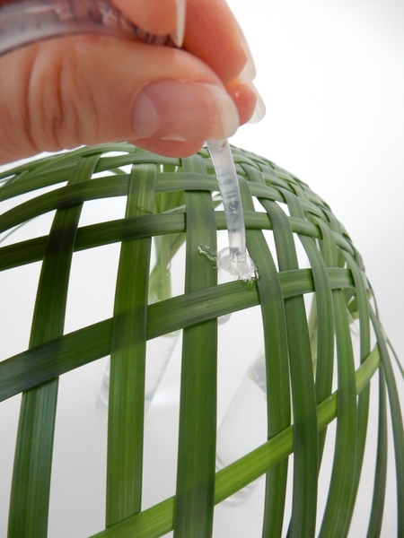 Glue in tiny drinking straw test tubes to keep the orchids hydrated Glue in tiny drinking straw test tubes to keep the orchids hydrated