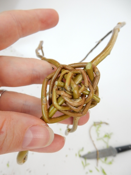 Weave the stem in and out spiralling out around the stems Weave the stem in and out spiralling out around the stems