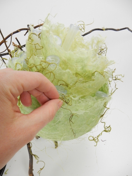 Add bits of dried Spanish moss to create texture Add bits of dried Spanish moss to create texture