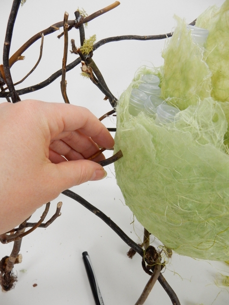 Pierce the twig tangle through the paper to suspend the wasp nest