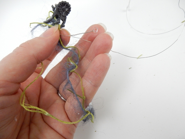 Wrap short strips of beaded wire around the moss and wool Wrap short strips of beaded wire around the moss and wool