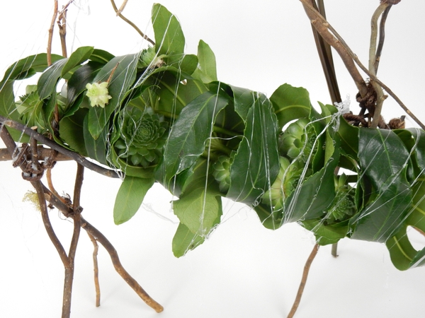 Hot glue web to secure the leaves to the armature Hot glue web to secure the leaves to the armature