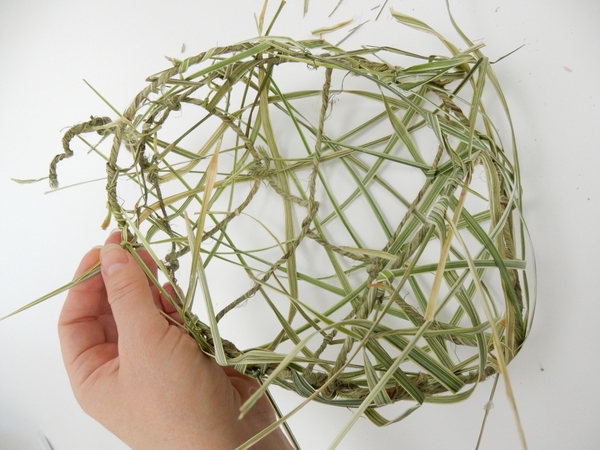 Knot and weave in grass to fill in the gaps and break up the wire and grid pattern Knot and weave in grass to fill in the gaps and break up the wire and grid pattern