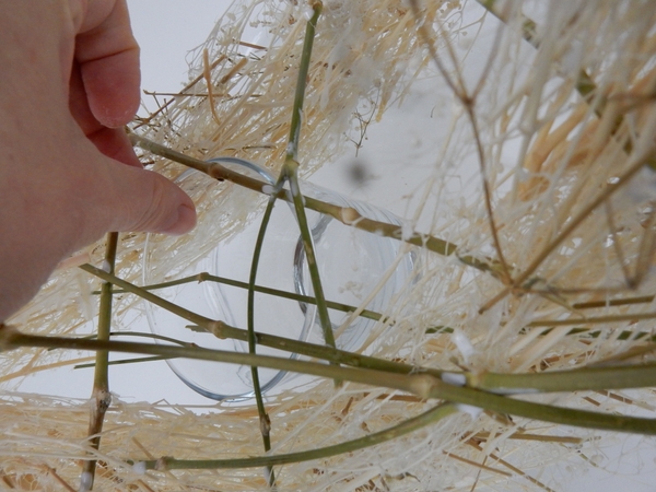 Slip a vase under the armature to keep the flower material hydrated Slip a vase under the armature to keep the flower material hydrated