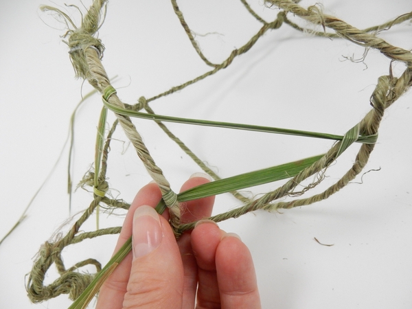 Weave a blade of grass through the structure to create the nest Weave a blade of grass through the structure to create the nest