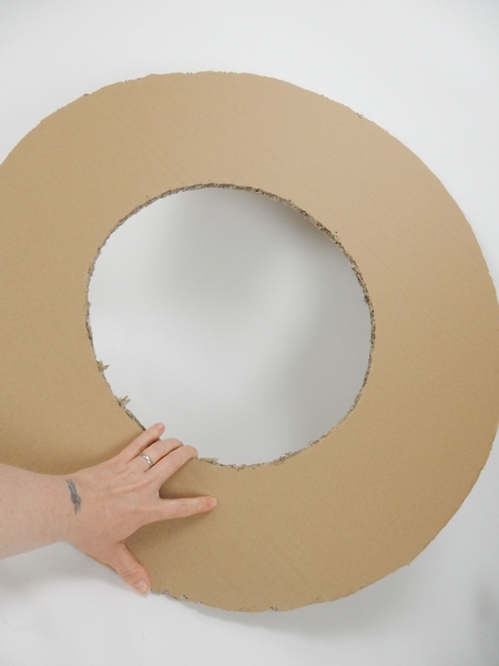 Cut a large circle out of cardboard Cut a large circle out of cardboard