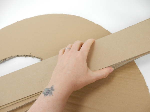 Cut strips of cardboard as thick as you want the wreath to be Cut strips of cardboard as thick as you want the wreath to be