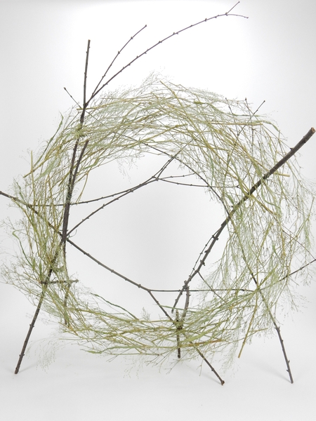 Glue in a few twigs to make the wreath stand upright. Glue in a few twigs to make the wreath stand upright.