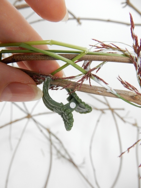 Secure the grass to the vine with a drop of glue Secure the grass to the vine with a drop of glue