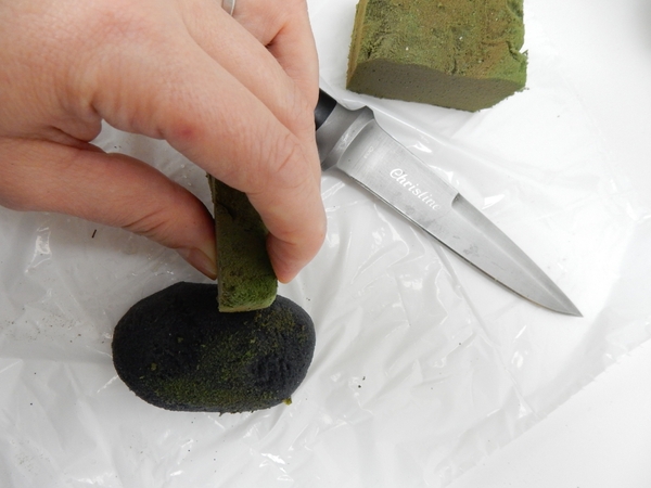 Smooth the soaked foam with an off cut of green foam to give it a mossy appearance Smooth the soaked foam with an off cut of green foam to give it a mossy appearance