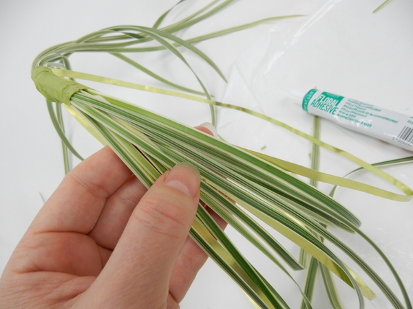 Bend the grass down to the side of the basket and secure with floral glue to the wire Bend the grass down to the side of the basket and secure with floral glue to the wire