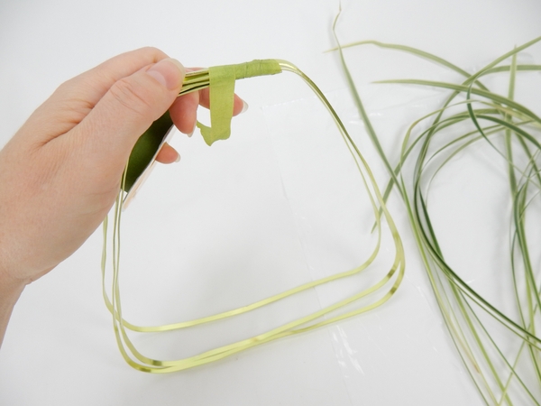 Connect the open ends at the top with florist tape. This area will be the handle of the basket Connect the open ends at the top with florist tape. This area will be the handle of the basket
