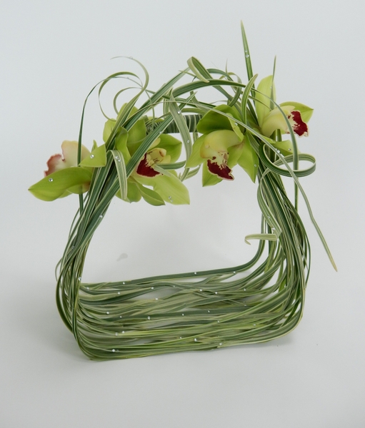 Cymbidium orchids and curled grass with crystals on a bridal basket Cymbidium orchids and curled grass with crystals on a bridal basket