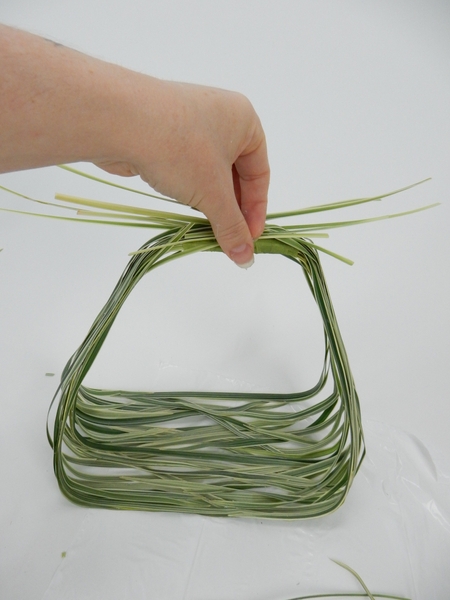 Gather up the stem ends at the handle side of the basket Gather up the stem ends at the handle side of the basket