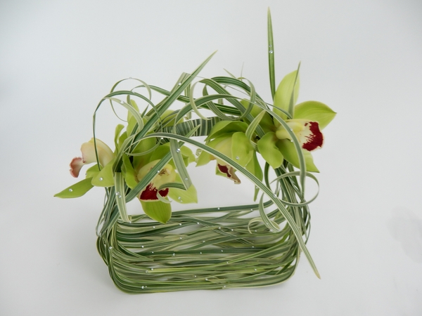 Glue in a few dangling blades of grass, some snowflake sparkling beads, and the orchids Glue in a few dangling blades of grass, some snowflake sparkling beads, and the orchids