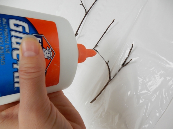Pour out a few drops of wood glue on to the twigs Pour out a few drops of wood glue on to the twigs
