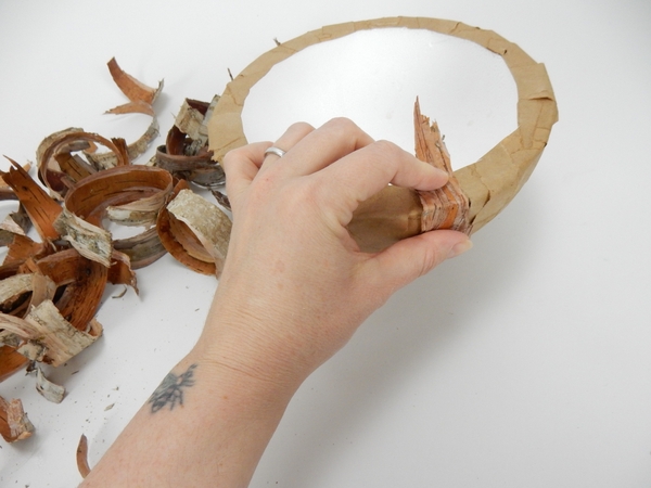 Rip bark into long strips and glue it to the paper covered shape Rip bark into long strips and glue it to the paper covered shape