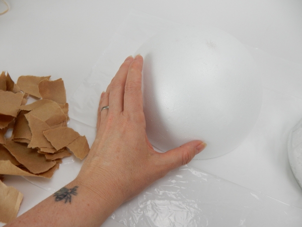 Rip up some brown paper and place the shape on a flat working surface Rip up some brown paper and place the shape on a flat working surface
