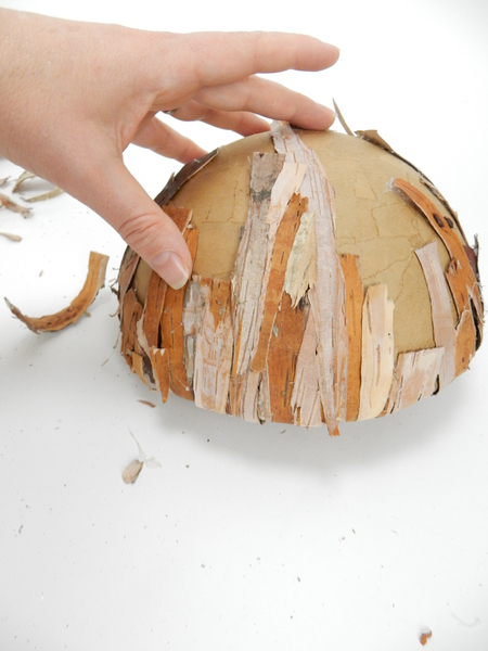 Turn the shape around and glue strips of bark to the underside