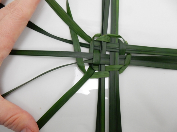 Open up the strands and weave the grass garland through Open up the strands and weave the grass garland through