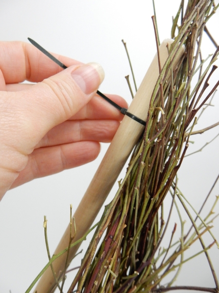 Secure the twig bundle to the stick with cable ties