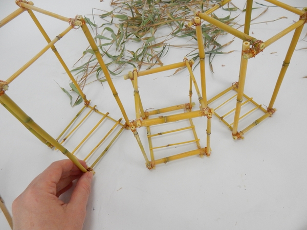 Glue or wire bamboo lengths to create the base for the lantern Glue or wire bamboo lengths to create the base for the lantern