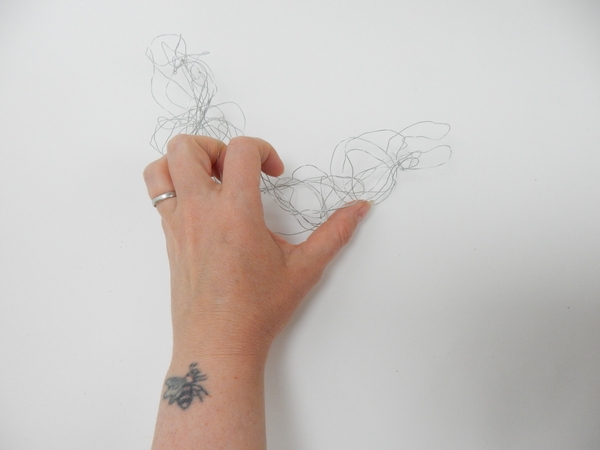 Tangle and shape wire into a half moon Tangle and shape wire into a half moon
