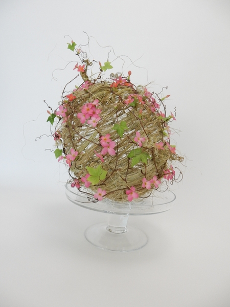 Hedera and phormium and kalanchoe wrapped woven pumpkin Hedera and phormium and kalanchoe wrapped woven pumpkin