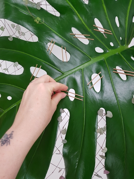 Make sure to position the sticks in such a way that it would be concealed by the flower placement Make sure to position the sticks in such a way that it would be concealed by the flower placement