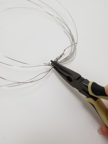 Twist the end pieces together to shape the stalk Twist the end pieces together to shape the stalk