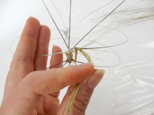 Wrap the flax around the wire extend it to the next wire and wrap it around that wire Wrap the flax around the wire extend it to the next wire and wrap it around that wire