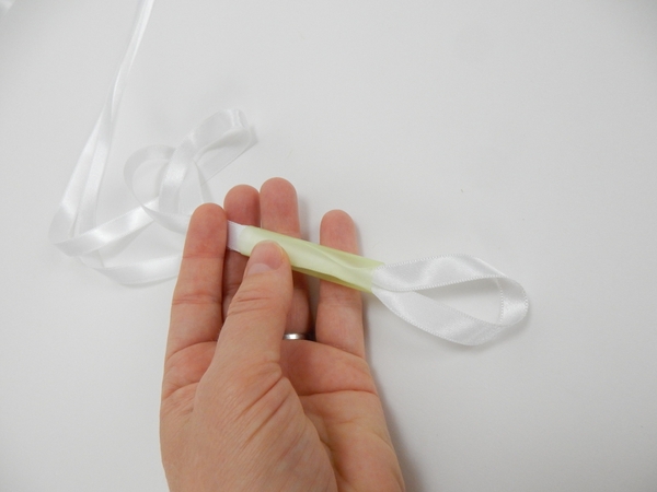 Fold a length of ribbon in half and slip it through the straw Fold a length of ribbon in half and slip it through the straw